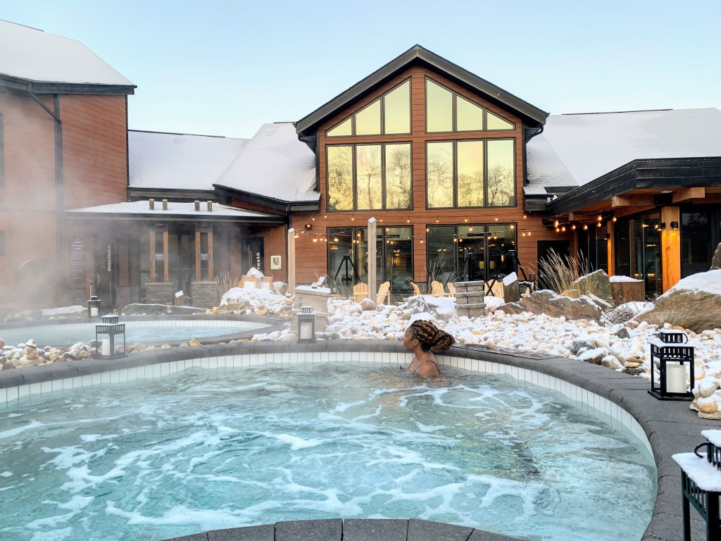 A profile view of Claire in the pool in front of the spa.