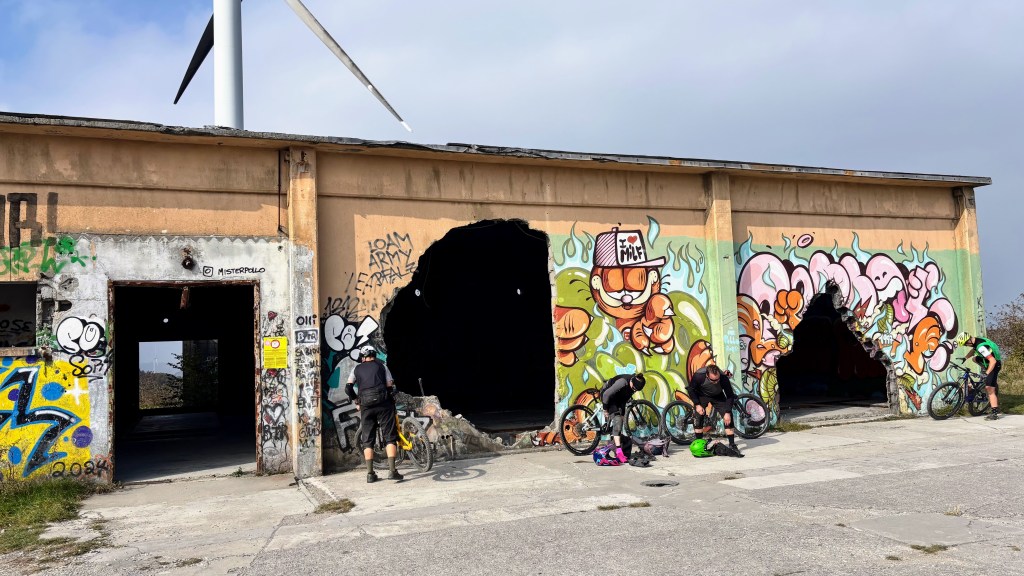 Mountain bikers preparing to ride at the NATO Base trailhead in Finale Ligure, Italy